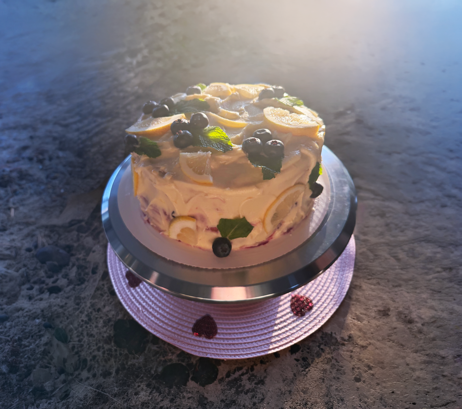 Lemon blueberry layer cake topped with fresh fruit